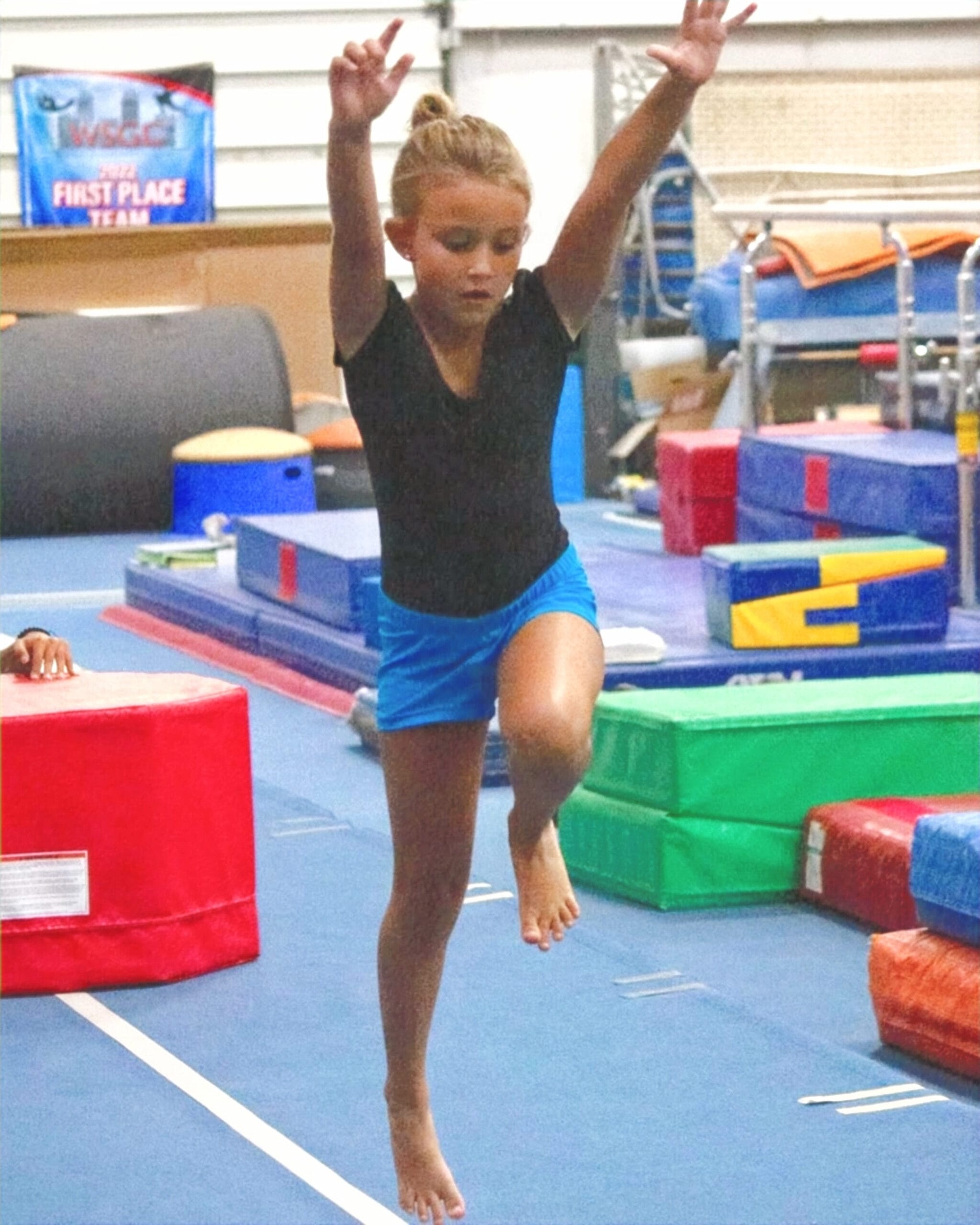 Girl performing a cartwheel in a Gymnastics Class