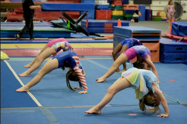 A group of girls practicing tumbling